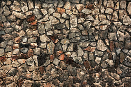 old masonry of rough stones as a backgroundの写真素材