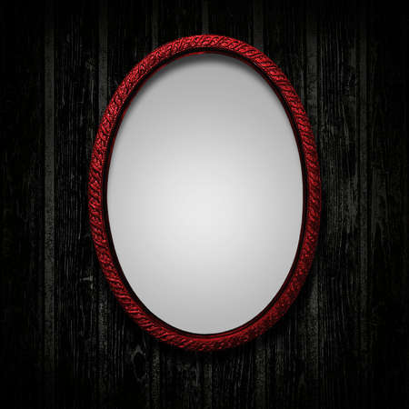 Dark red picture frame on black grunge wooden backgroundの写真素材
