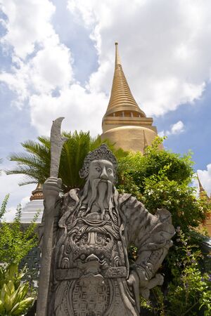 Chinese stone sculpture guards the picture was taken on sunny days. The golden pagoda is picturesque and the beautiful clouds.の写真素材
