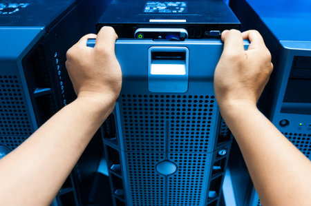 Man fix server network in data center room .
