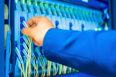 People fix node fiber optic in network room .の写真素材
