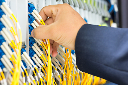 People fix node fiber optic in network room .の写真素材