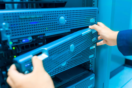 Man fix server network in data center room .
