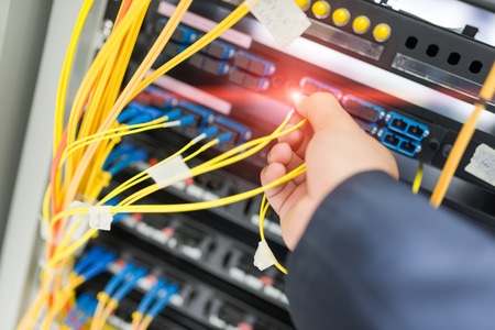 People fix node fiber optic in network room .の写真素材