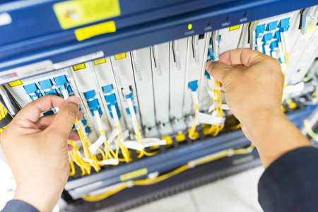 People fix node fiber optic in network room .