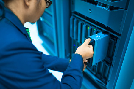 Man fix server network in data center room .