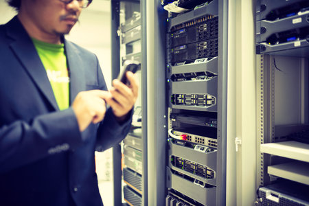 Man fix server network in data center room .