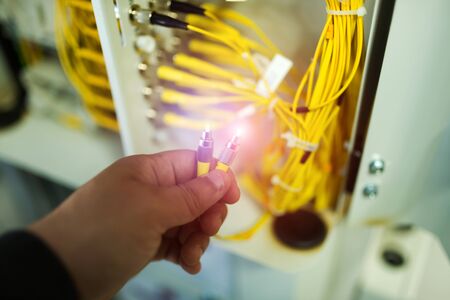 People fix node fiber optic in network room .の写真素材