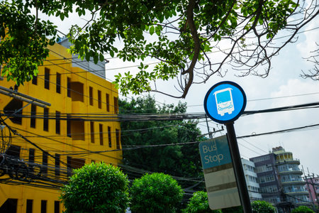 A stock photo of a bus stop typically features an image of a bus stop or bus shelter, which is a designated place where people can wait for a public bus to arrive.の写真素材