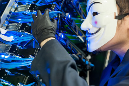 Masked Hacker in Computer Server room Concept .Editorial photo