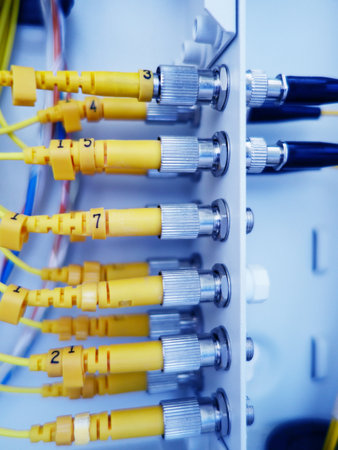 Fiber Optic cables connected to an optic ports. Selective focus.の写真素材