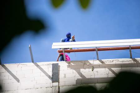 Working at heights without protective equipmentの写真素材