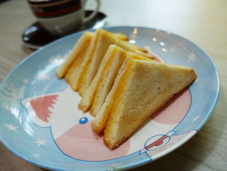 Toast bread on plate with cup of coffee in the morning.の写真素材