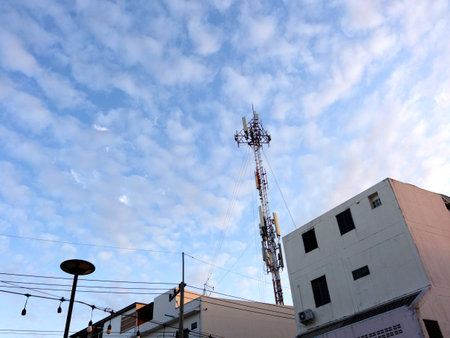 Telecommunication tower with blue sky and white clouds, technology backgroundの写真素材