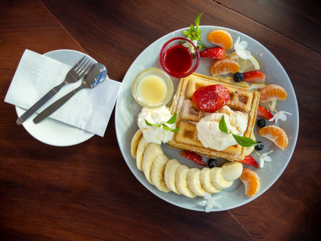waffle with ice cream and fruits on wood table, top viewの写真素材