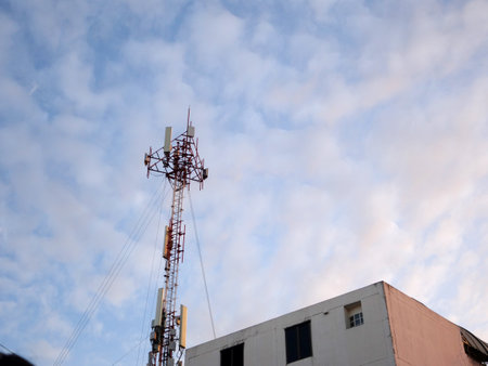 Telecommunication tower with blue sky and white clouds, technology backgroundの写真素材
