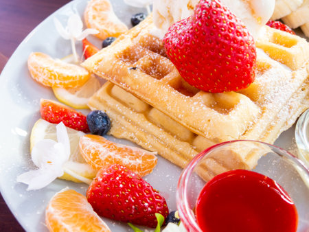 waffle with ice cream and fruits on wood table, top viewの写真素材