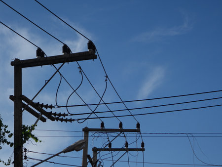 An electrical pole that shows the disorder in the arrangement of the cables.の写真素材