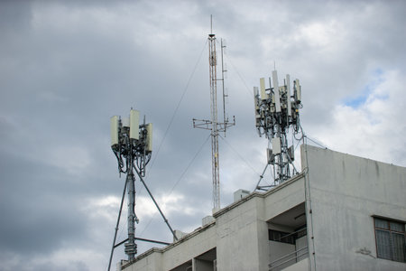 Telecommunication tower with blue sky and white clouds, technology background.の写真素材