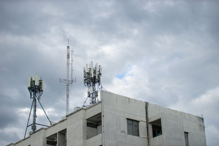 Telecommunication tower with blue sky and white clouds, technology background.の写真素材