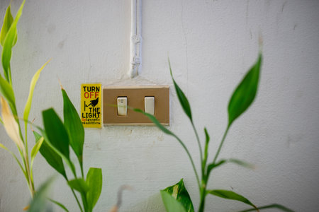 Light switch with a sign: Help love the world.の写真素材