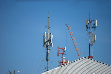 Telecommunication tower with blue sky and white clouds, technology background.の写真素材