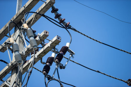 An electrical pole that shows the disorder in the arrangement of the cables.