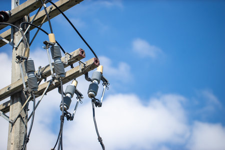 An electrical pole that shows the disorder in the arrangement of the cables.の写真素材