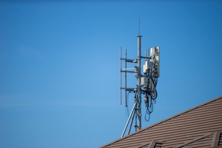 Telecommunication tower with blue sky and white clouds, technology background.の写真素材