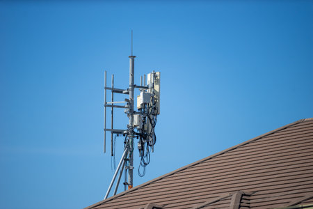 Telecommunication tower with blue sky and white clouds, technology background.の写真素材
