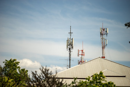 Telecommunication tower with blue sky and white clouds, technology background.の写真素材