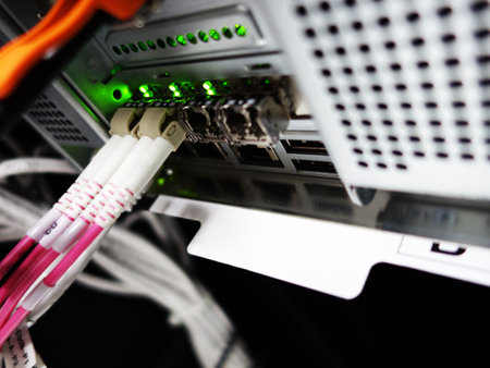 close-up of network cables connected to server in data center roomの写真素材