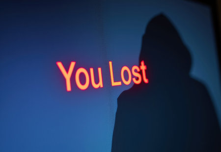 A man figure stares intently at a computer screen displaying a stark red "You Lost" message amidst lines of code, evoking a sense of tension and potential defeat in a cyber-security scenario.の素材