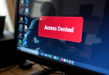 A shadow hacker in front of a computer screen displaying "Access Denied" in red text, representing cybersecurity threats and hacking.の素材