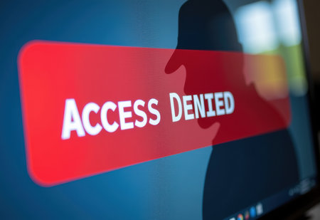 A shadow hacker in front of a computer screen displaying "Access Denied" in red text, representing cybersecurity threats and hacking.の素材