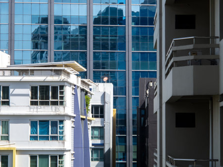 A captivating view of modern urban architecture showcasing glass reflections and intricate building designs, highlighting the vibrant city life.の写真素材