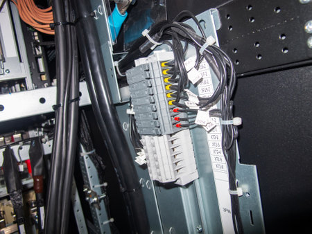 This image showcases a close-up view of an electrical control panel, highlighting wiring, connectors, and modules for industrial applications.の写真素材
