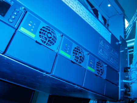 A close-up view of industrial equipment featuring a cooling system in a blue-lit environment, showcasing modern technology and machinery efficiency.の写真素材