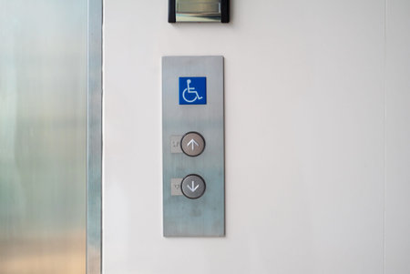 This image features an accessible elevator call panel with clear directional buttons for up and...
