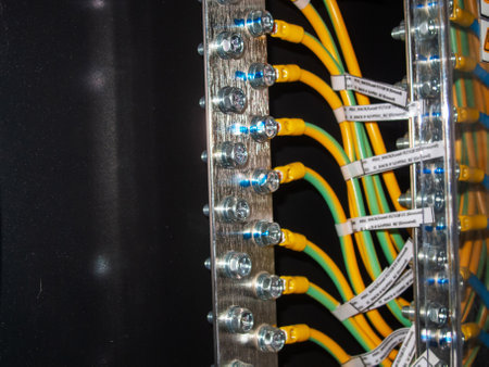 Detailed view of cable connections in an electrical distribution system, showcasing various color-coded wires and terminals for effective connectivity and organization.の写真素材