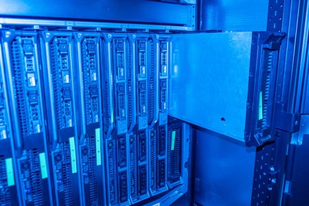 This image showcases a high-tech server rack within a data center, illuminated by blue lighting. It...