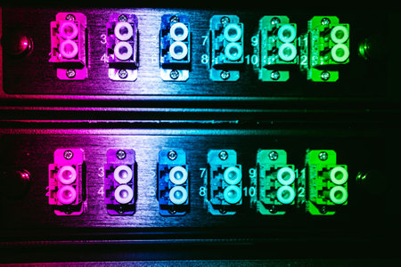 This vibrant image showcases a connector panel with multiple inputs and outputs, illuminated in...