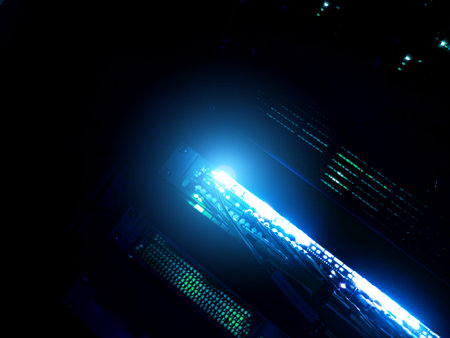 An abstract view of a computer server with vibrant blue light emitting from its structure. The image...