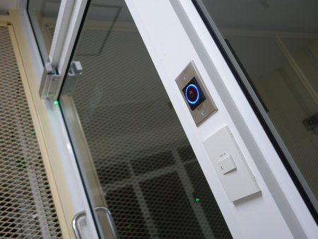 A close-up view of a modern entry system featuring a doorbell and light switch, showcasing sleek design and user-friendly technology for enhanced security and convenience.の写真素材