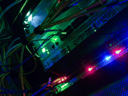A vibrant display of network cables and illuminated lights inside a server room, showcasing the...