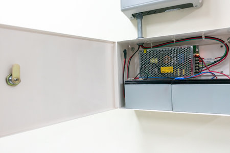 Detailed view of a power supply unit and wiring inside a modern electrical box. This image highlights essential components for electrical installations and safety.の写真素材