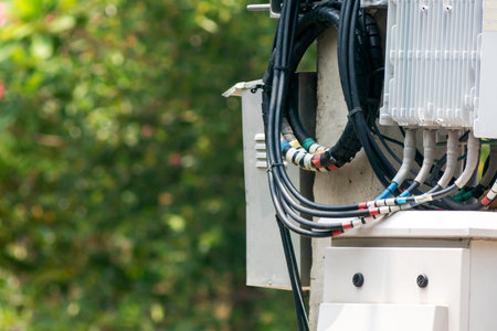 This image features a close-up view of electrical equipment with various wires and cables installed...