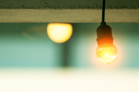 A warm hanging light bulb casts a gentle glow in a soft ambient setting, creating a cozy atmosphere...