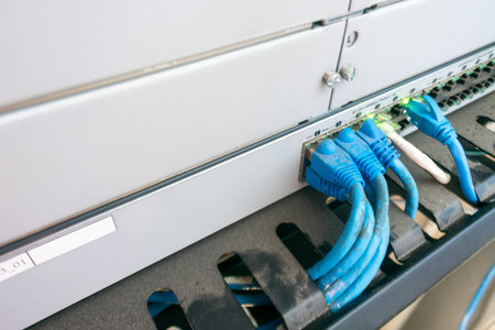 Close-up of Ethernet cables connected to a network switch, showcasing modern technology and...