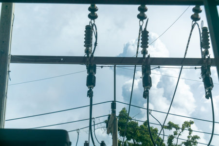 A captivating view of power lines against a cloudy blue sky, capturing the essence of energy...